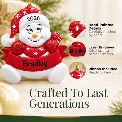 Hand-painted details and laser engraved personalization on the red snowbaby christmas ornament, ribbon included
