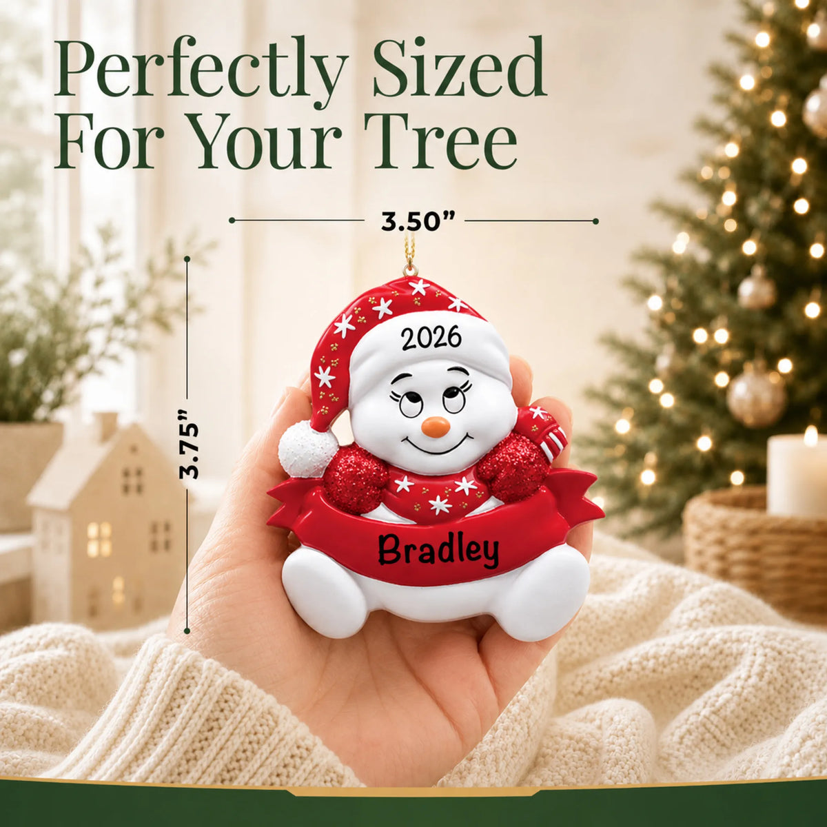 Size guide: the personalized red snowbaby christmas ornament is 3.50 in wide by 3.75 in tall, shown in hand