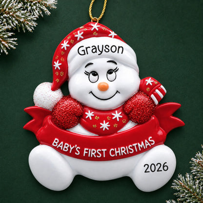 Personalized red baby's 1st christmas snowman ornament on a dark green pine background