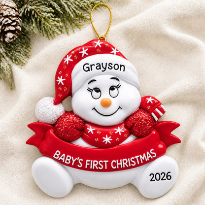 Personalized red baby's 1st christmas snowman ornament laid on a soft white knit blanket