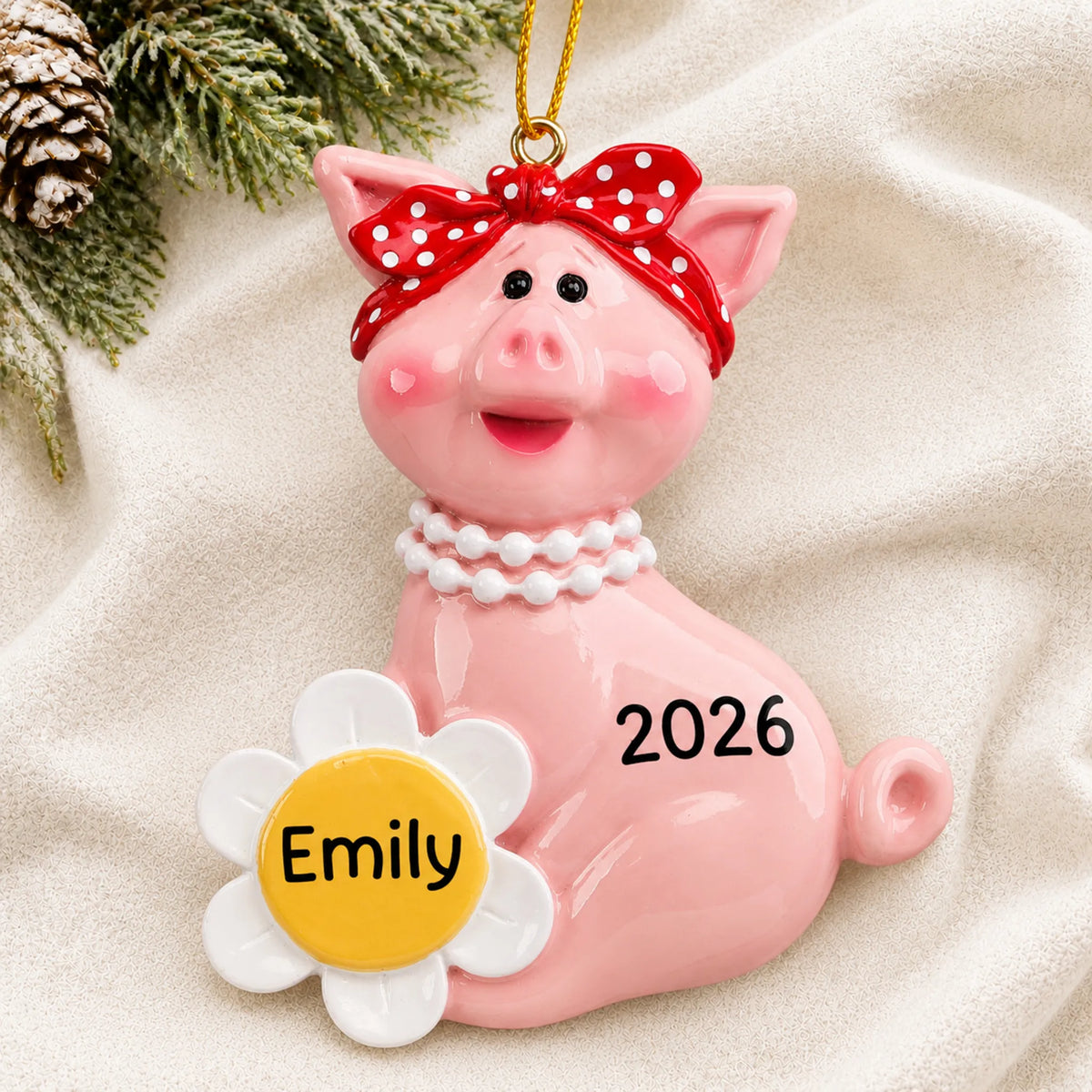 Personalized little piggy christmas ornament laid on a soft white knit blanket
