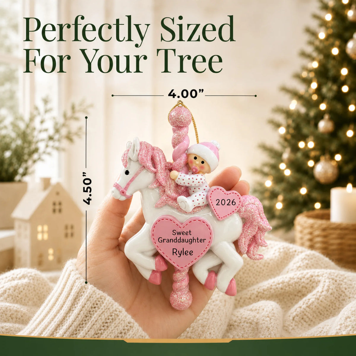 Size guide: the personalized granddaughter pink baby carousel christmas ornament shown in hand next to a Christmas tree