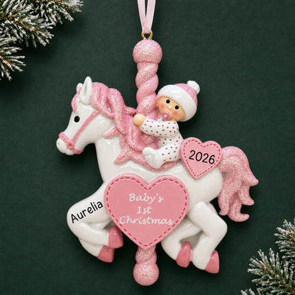 Personalized pink baby's 1st christmas carousel ornament on a dark green pine background