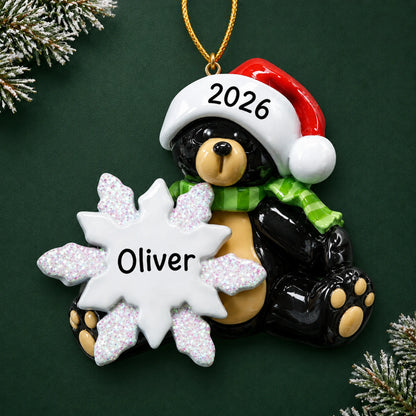 Personalized sitting black bear christmas ornament on a dark green pine background