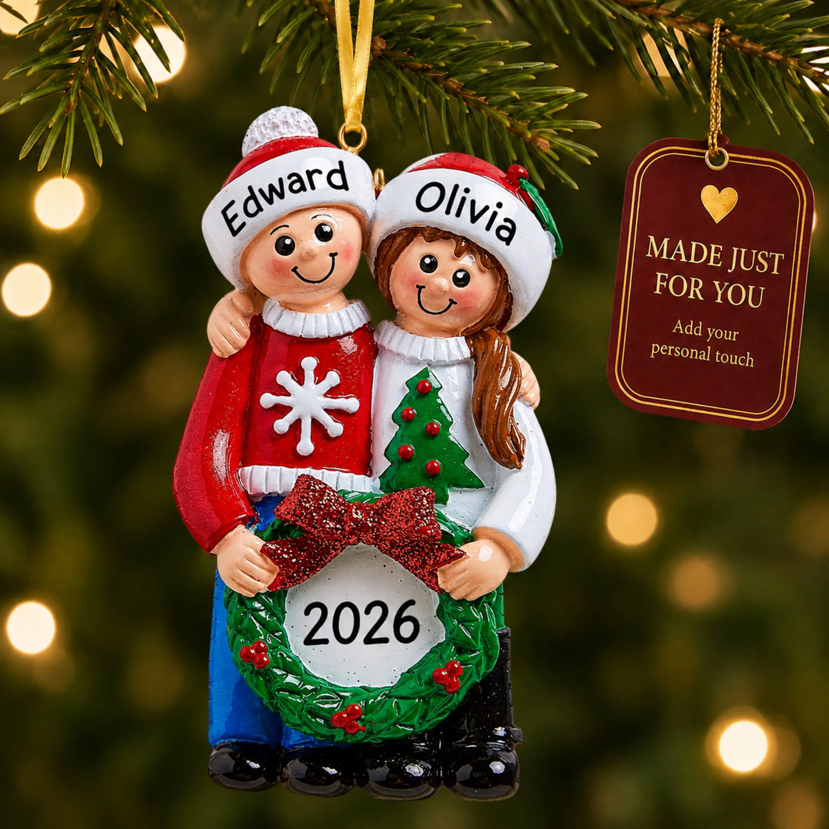 Ugly sweater couple christmas ornament hanging on a lit Christmas tree with a Made Just For You gift tag