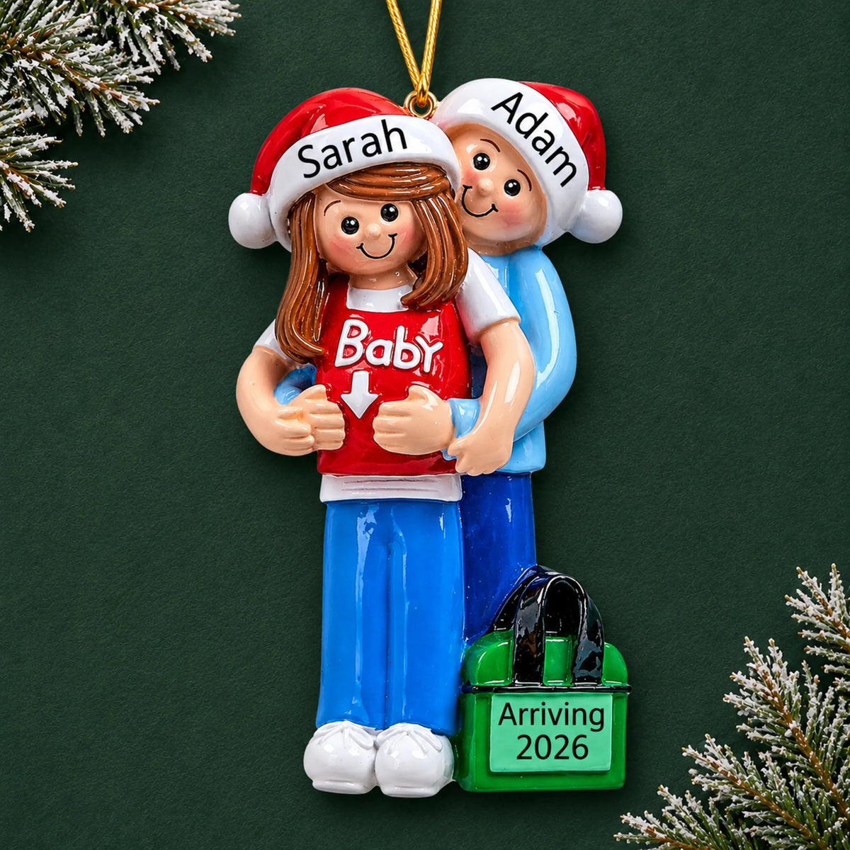 Brunette expecting couple personalized Christmas ornament on a dark green background, names on the Santa hats and year on the bag