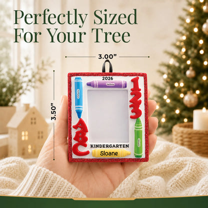 Personalized kindergarten photo frame Christmas ornament held in hand to show its size on the tree
