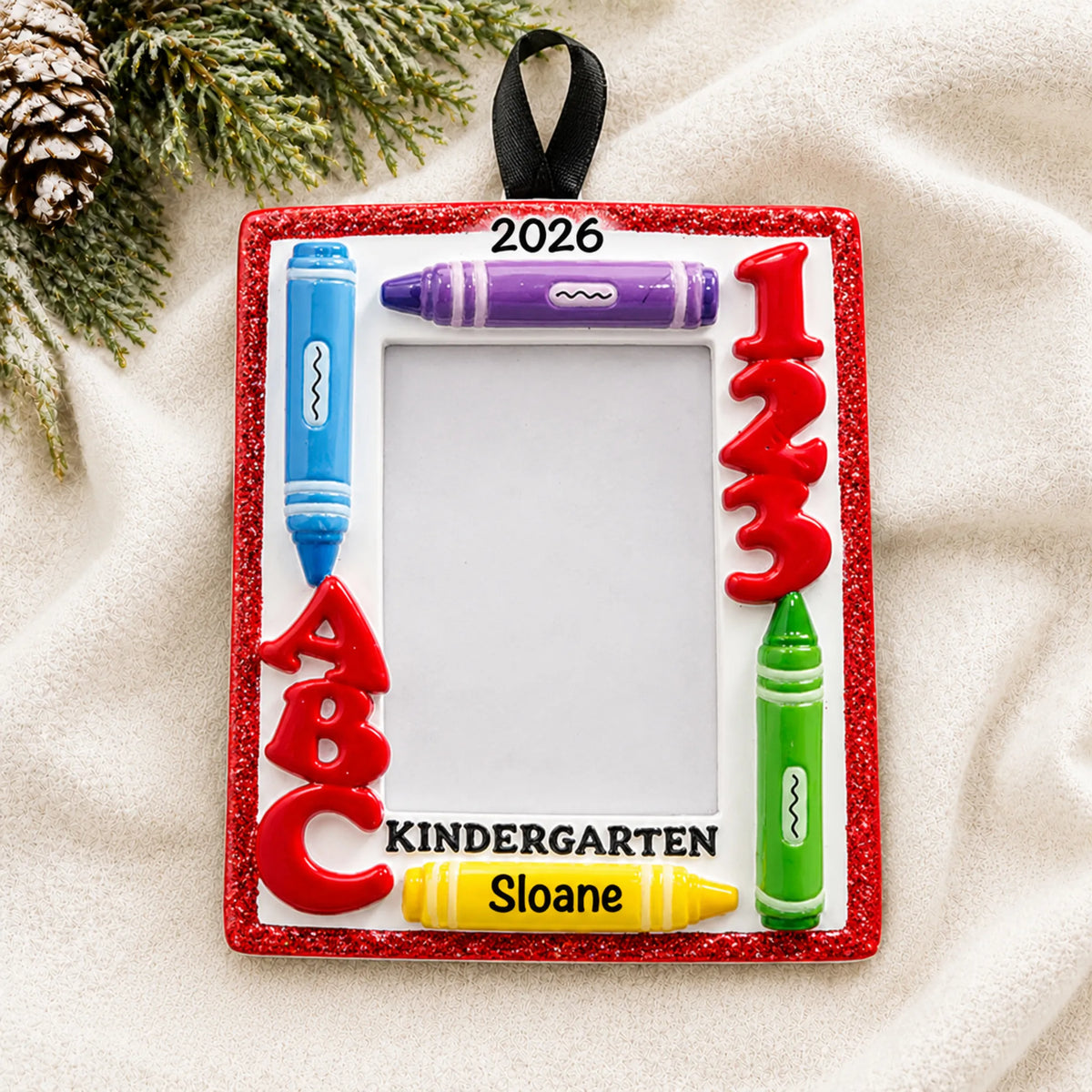 Personalized kindergarten photo frame Christmas ornament shown on a soft white blanket