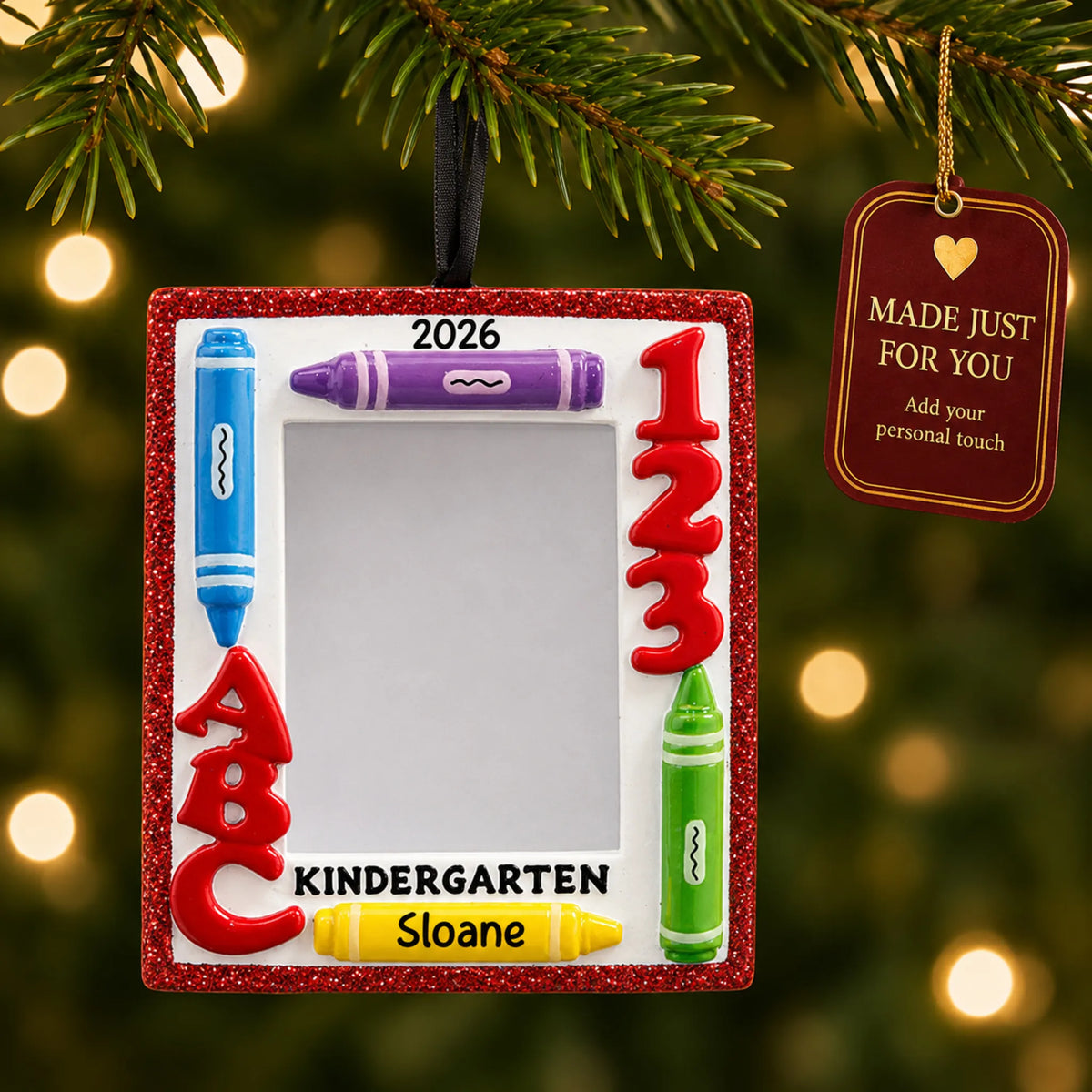 Personalized kindergarten photo frame Christmas ornament hanging among tree lights with a Made Just For You tag
