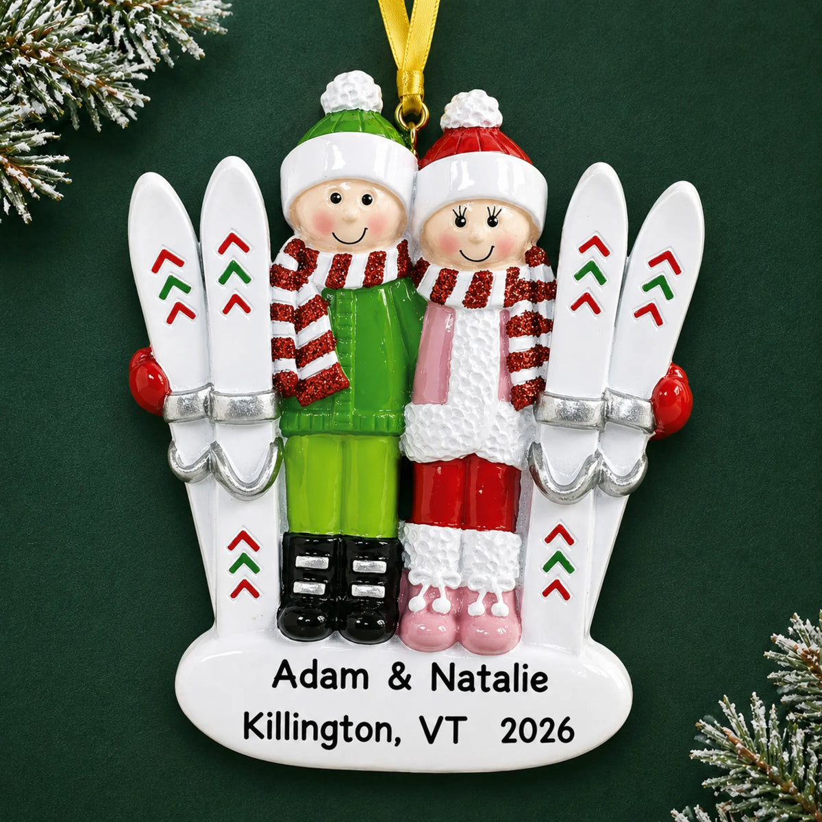 Personalized ski couple christmas ornament on a dark green pine background
