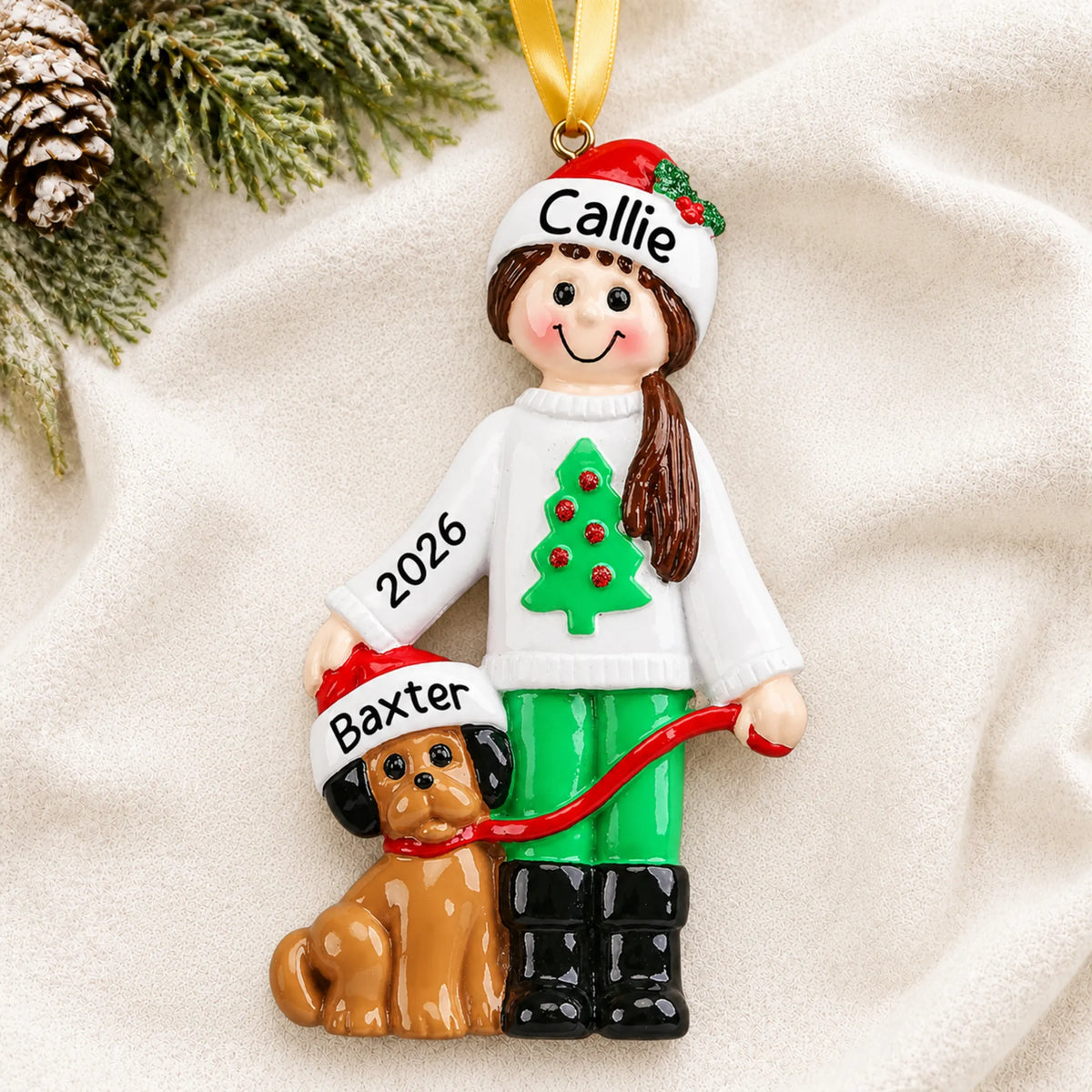 Personalized Girl With Dog christmas ornament laid on a soft white knit blanket