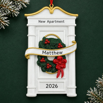 Personalized New or First Apartment christmas ornament on a dark green pine background