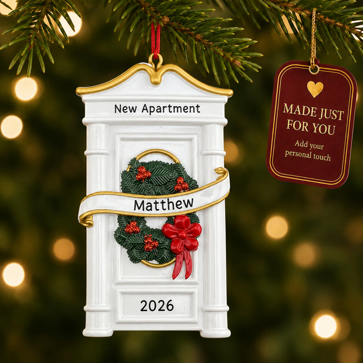 New or First Apartment christmas ornament hanging on a lit Christmas tree with a Made Just For You gift tag