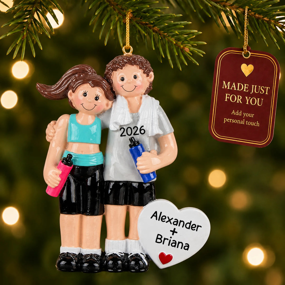 Workout couple christmas ornament hanging on a lit Christmas tree with a Made Just For You gift tag