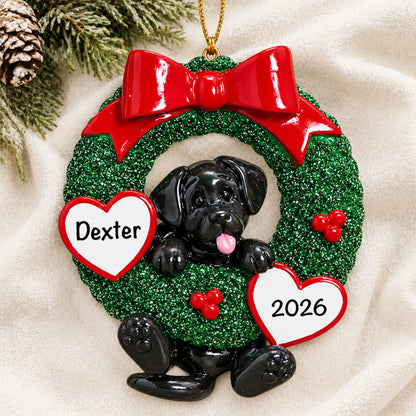 Personalized Black Lab Glitter Wreath christmas ornament laid on a soft white knit blanket