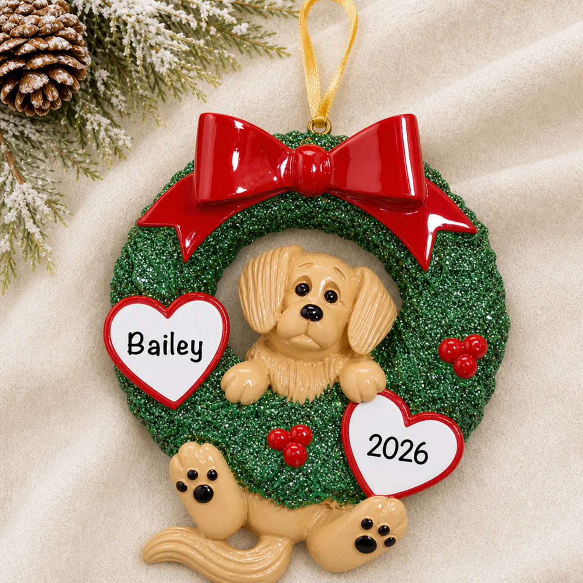 Personalized Golden Retriever Glitter Wreath christmas ornament laid on a soft white knit blanket