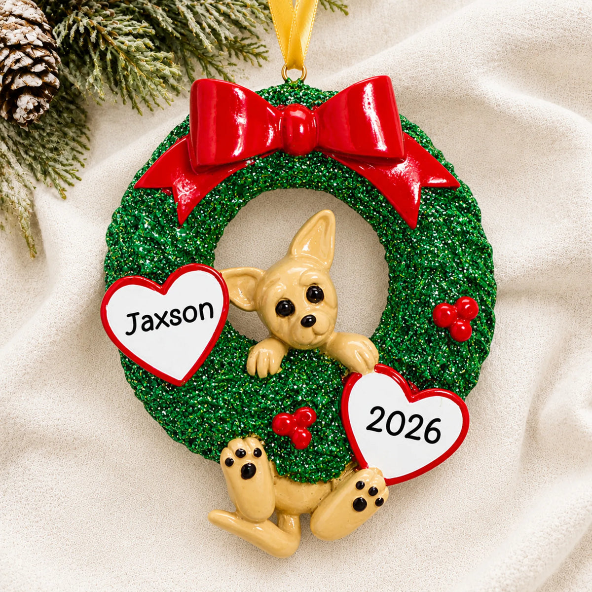 Personalized Chihuahua Glitter Wreath christmas ornament laid on a soft white knit blanket