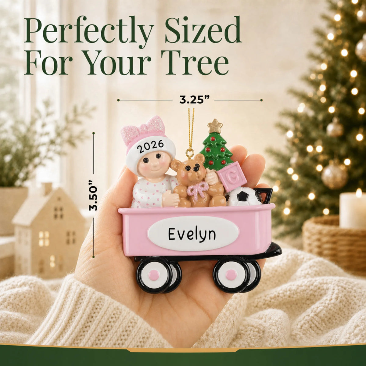 Size guide: the personalized pink wagon baby girl christmas ornament is 3.25 in wide by 3.50 in tall, shown in hand