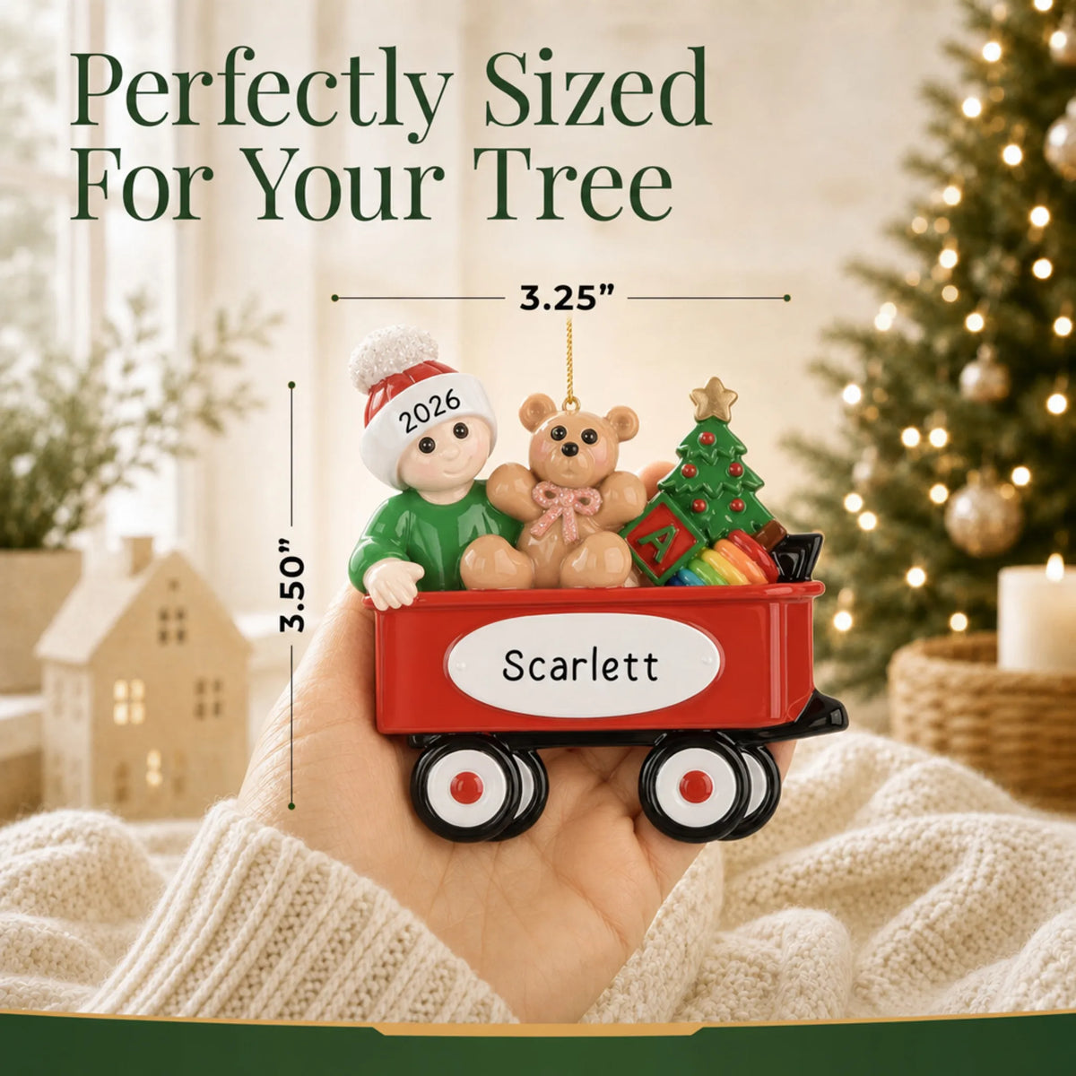 Size guide: the personalized red wagon baby christmas ornament is 3.25 in wide by 3.50 in tall, shown in hand