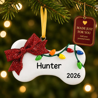 Holiday Lights Dog Bone christmas ornament hanging on a lit Christmas tree with a Made Just For You gift tag