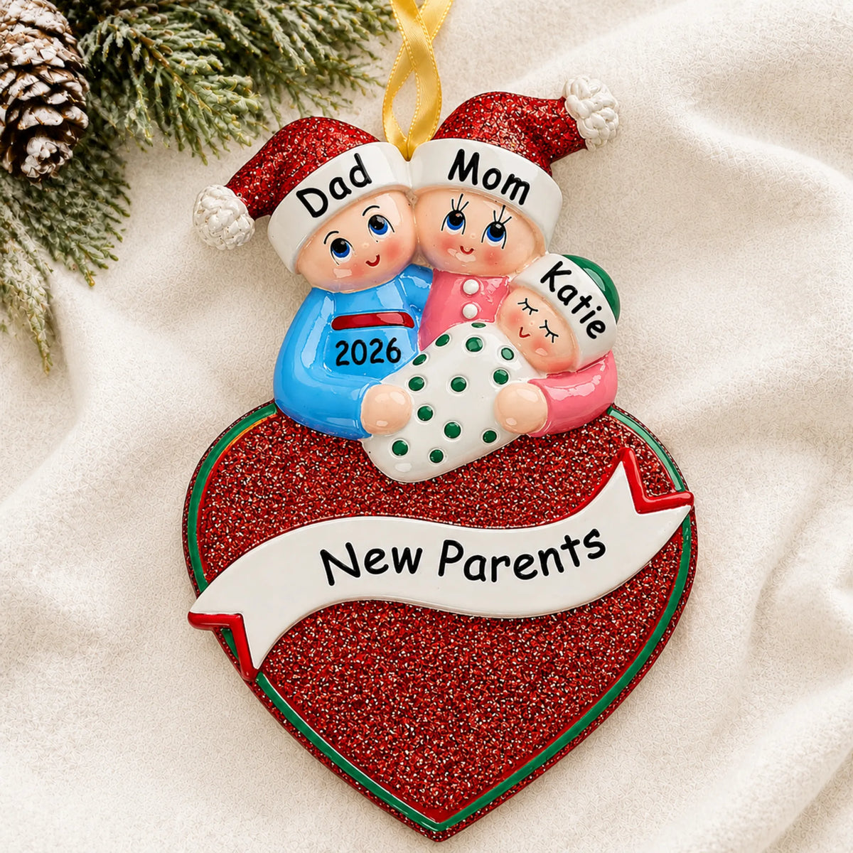 Personalized new parents christmas ornament laid on a soft white knit blanket