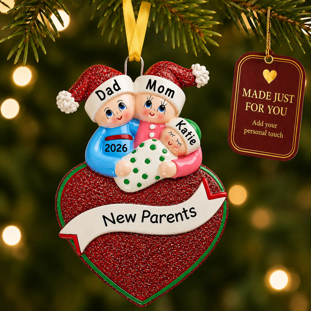 New parents christmas ornament hanging on a lit Christmas tree with a Made Just For You gift tag