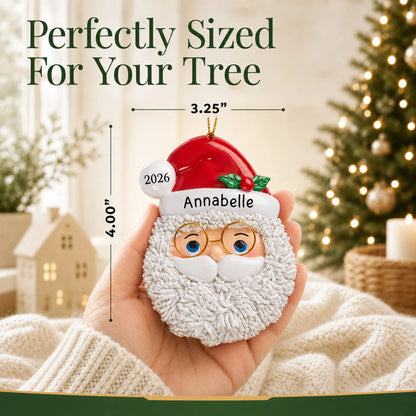 Size guide: the personalized Santa Claus christmas ornament is 3.25 in wide by 4.00 in tall, shown in hand