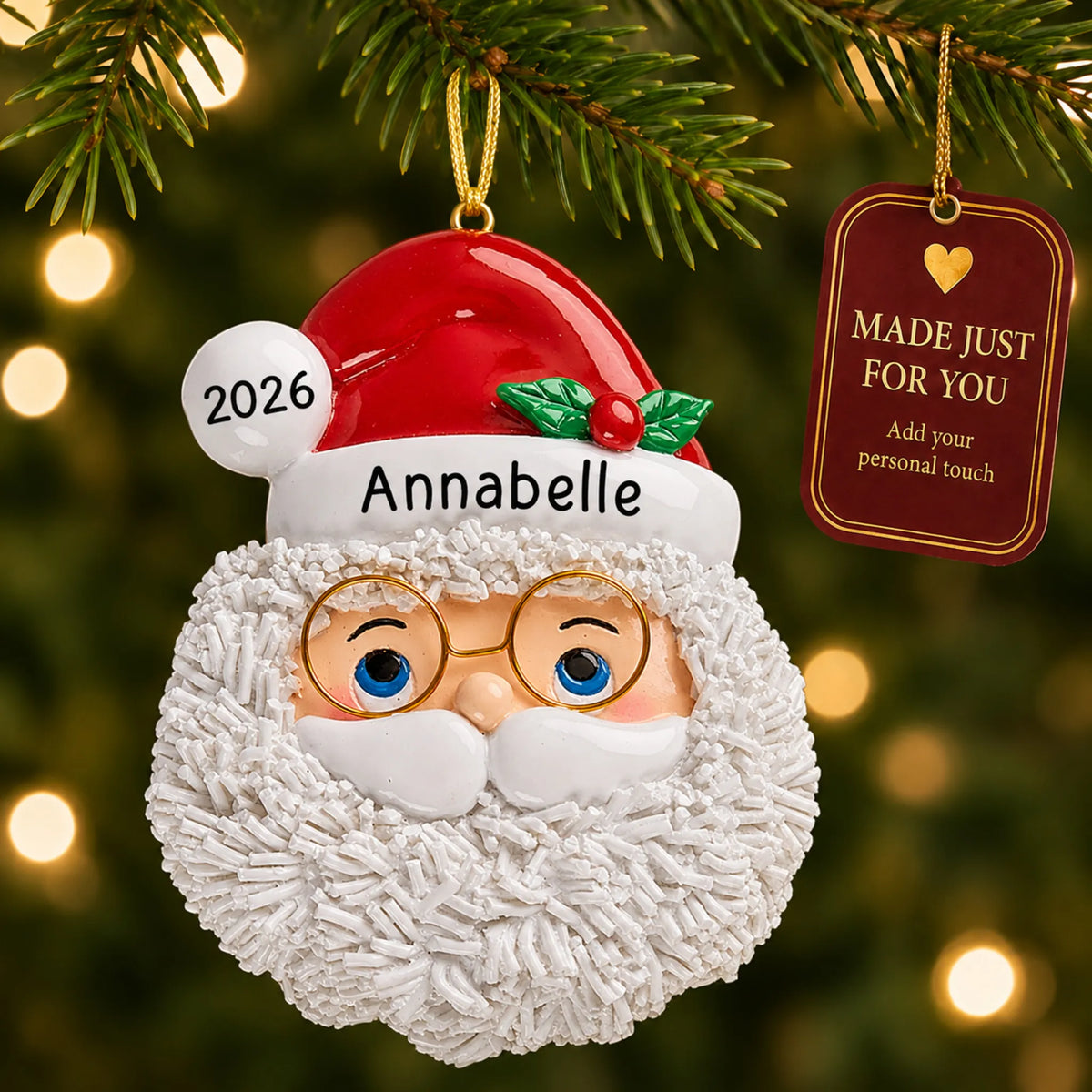 Santa Claus christmas ornament hanging on a lit Christmas tree with a Made Just For You gift tag
