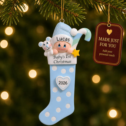 Blue baby's 1st christmas stocking ornament hanging on a lit Christmas tree with a Made Just For You gift tag