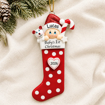 Personalized red baby's 1st christmas stocking ornament laid on a soft white knit blanket