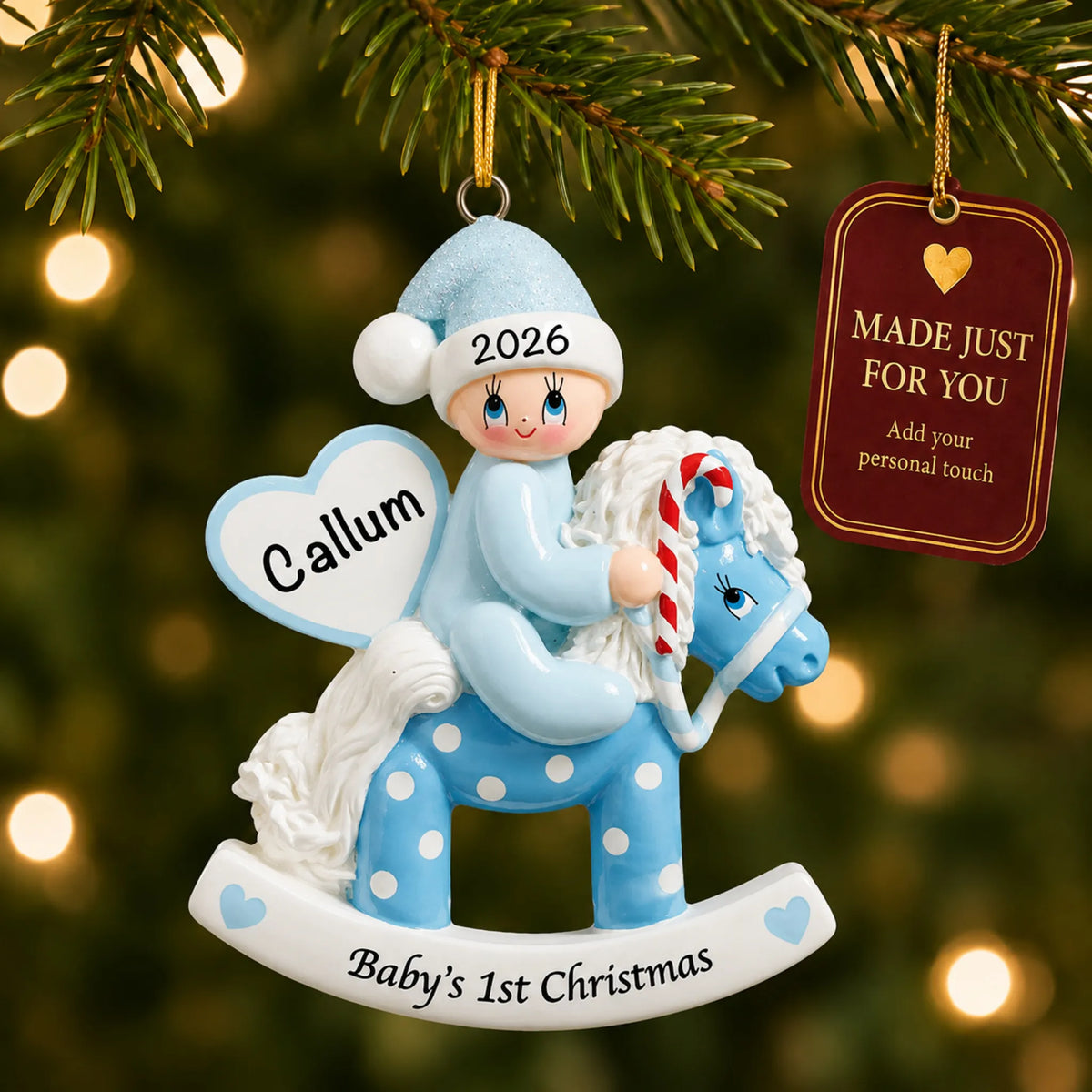 Blue baby's 1st christmas rocking horse ornament hanging on a lit Christmas tree with a Made Just For You gift tag