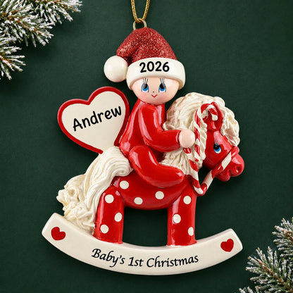 Personalized red baby's 1st christmas rocking horse ornament on a dark green pine background