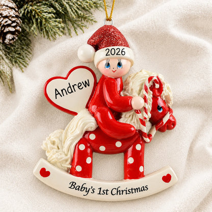 Personalized red baby's 1st christmas rocking horse ornament laid on a soft white knit blanket