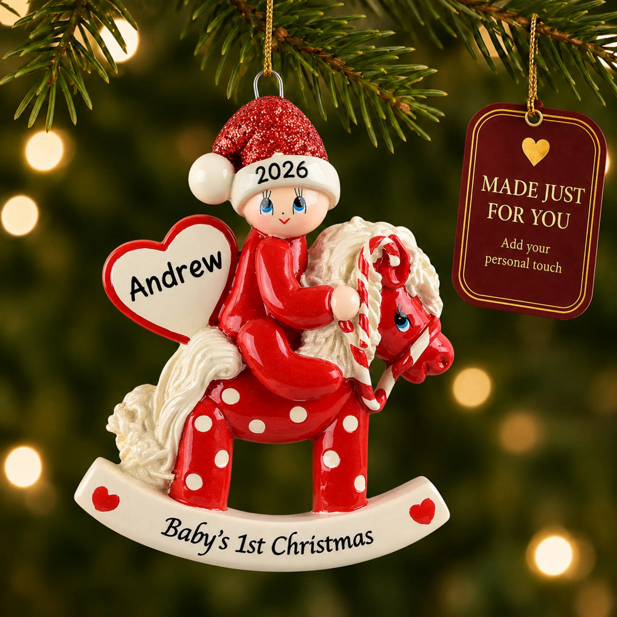 Red baby's 1st christmas rocking horse ornament hanging on a lit Christmas tree with a Made Just For You gift tag