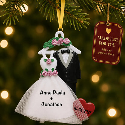 Personalized bride and groom attire Christmas ornament on a lit Christmas tree with a Made Just For You tag