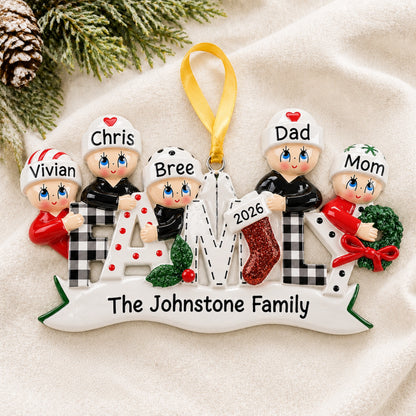 Personalized plaid family of 5 Christmas ornament hanging on tree with family name and 2026