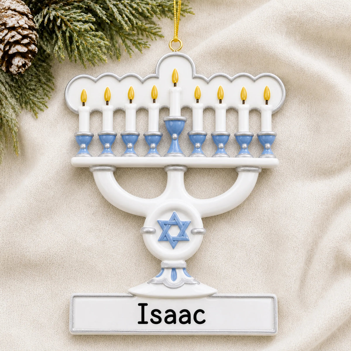 Personalized Menorah Hanukkah christmas ornament laid on a soft white knit blanket