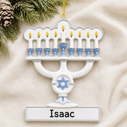 Personalized Menorah Hanukkah christmas ornament laid on a soft white knit blanket