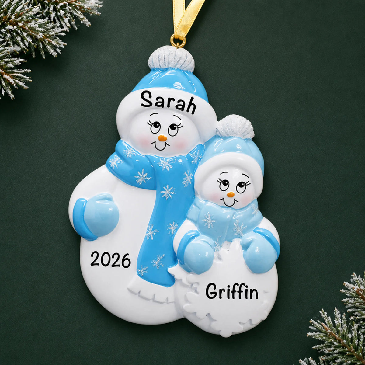 Personalized single parent snowman with 1 child christmas ornament on a dark green pine background