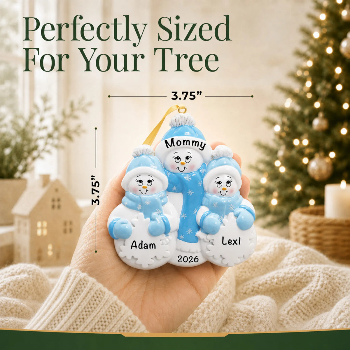 Size guide: the personalized single parent snowman with 2 children christmas ornament shown in hand next to a Christmas tree