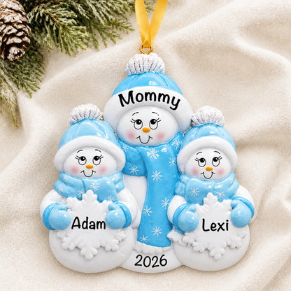 Personalized single parent snowman with 2 children christmas ornament laid on a soft white knit blanket