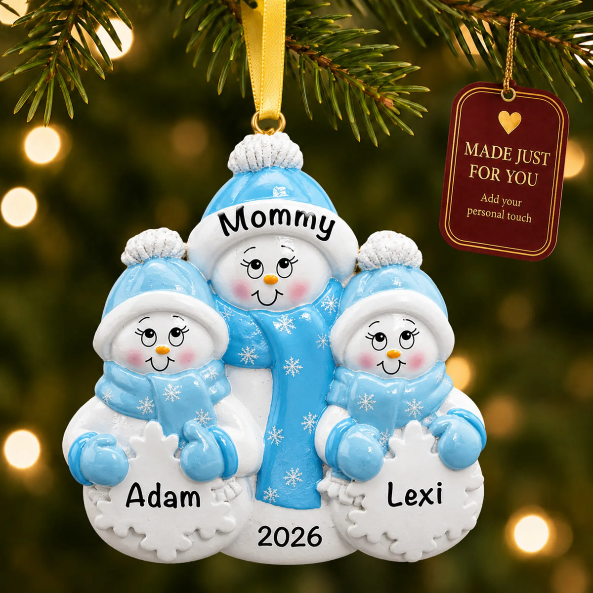 Single parent snowman with 2 children christmas ornament hanging on a lit Christmas tree with a Made Just For You gift tag