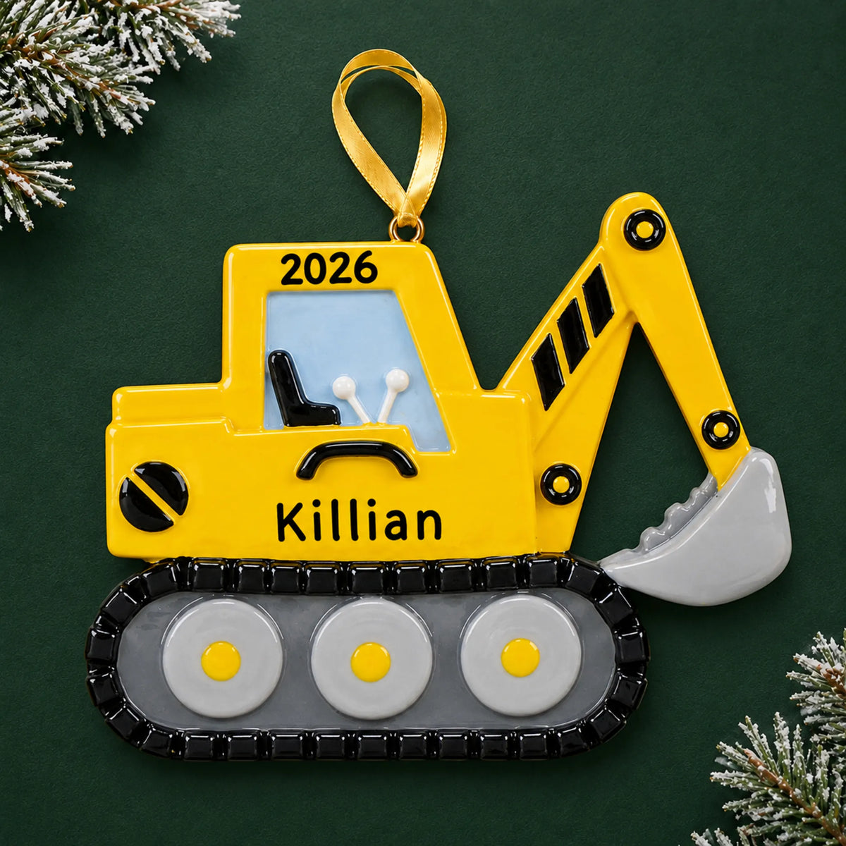 Personalized excavator christmas ornament on a dark green pine background
