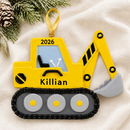 Personalized excavator christmas ornament laid on a soft white knit blanket