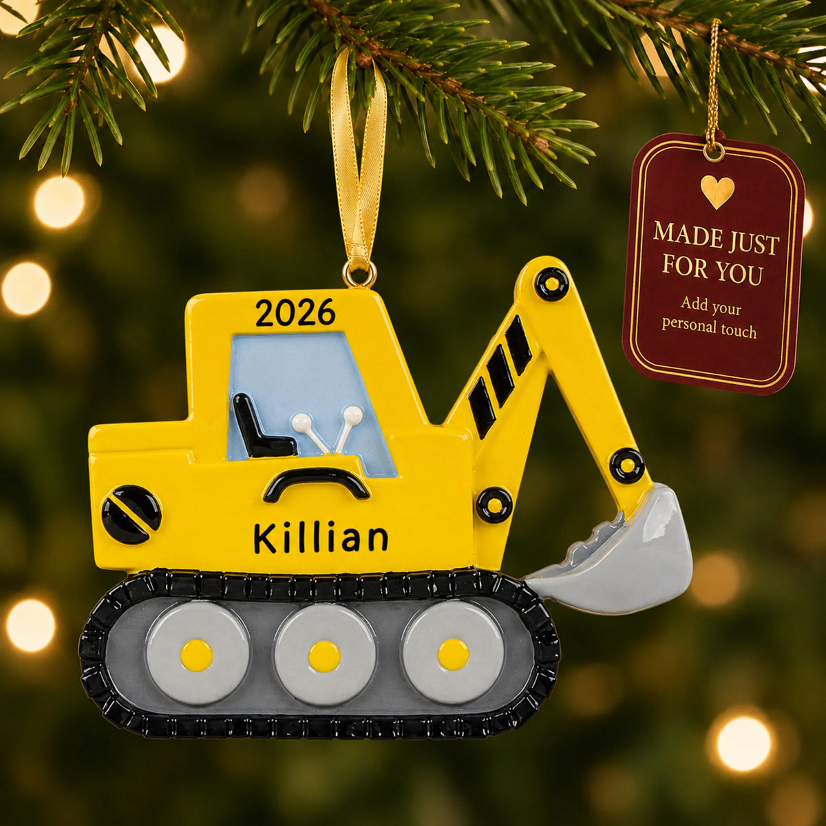 Excavator christmas ornament hanging on a lit Christmas tree with a Made Just For You gift tag
