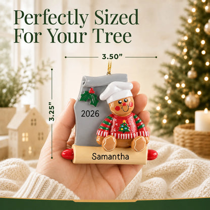 Size guide: the personalized Gingerbread Baker christmas ornament is 3.50 in wide by 3.25 in tall, shown in hand