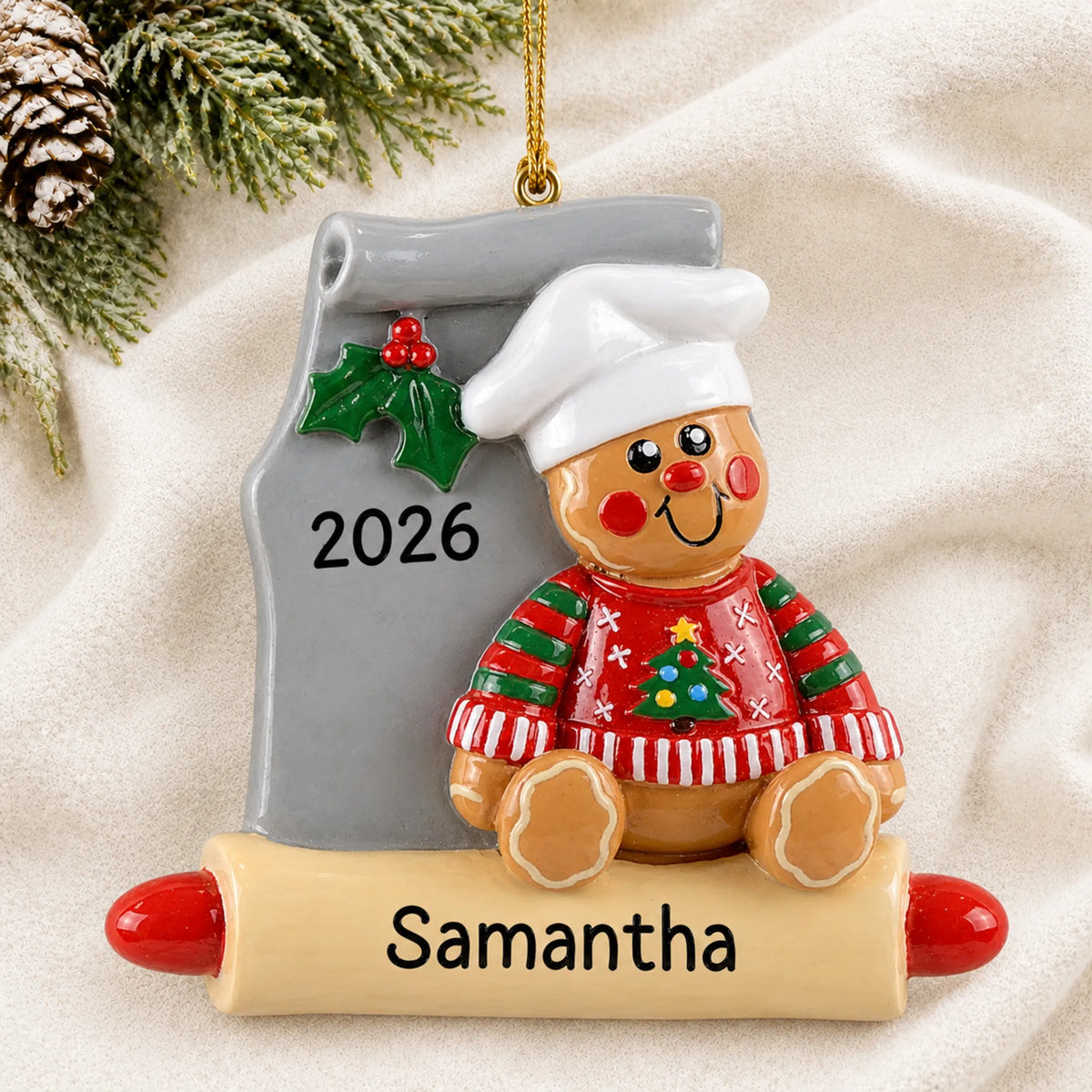 Personalized Gingerbread Baker christmas ornament laid on a soft white knit blanket