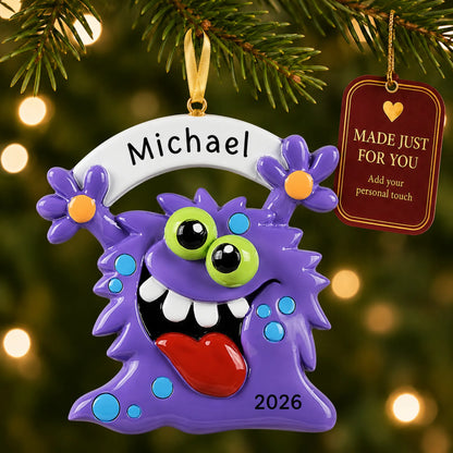 Purple monster christmas ornament hanging on a lit Christmas tree with a Made Just For You gift tag