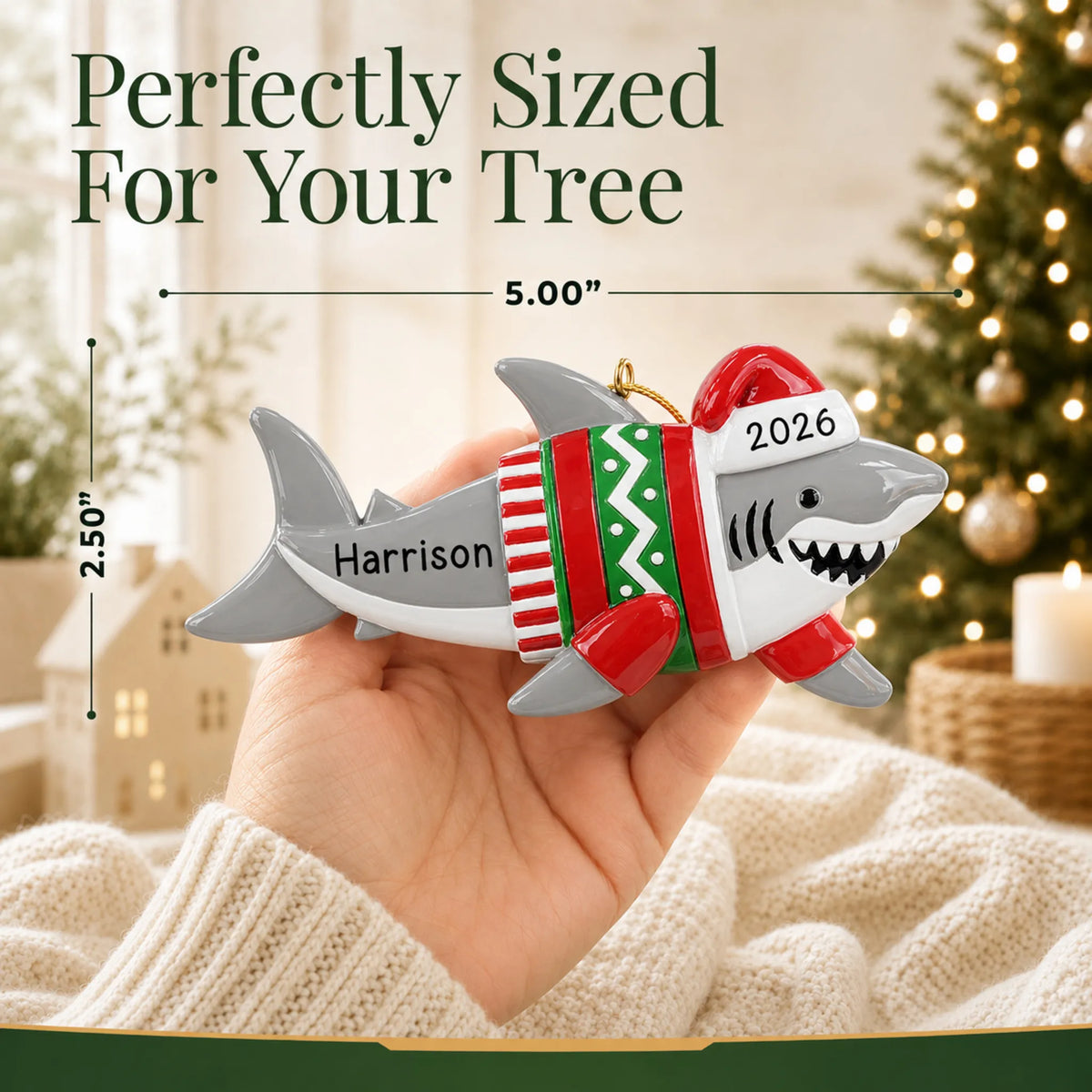Size guide: the personalized shark fun christmas ornament is 5.00 in wide by 2.50 in tall, shown in hand