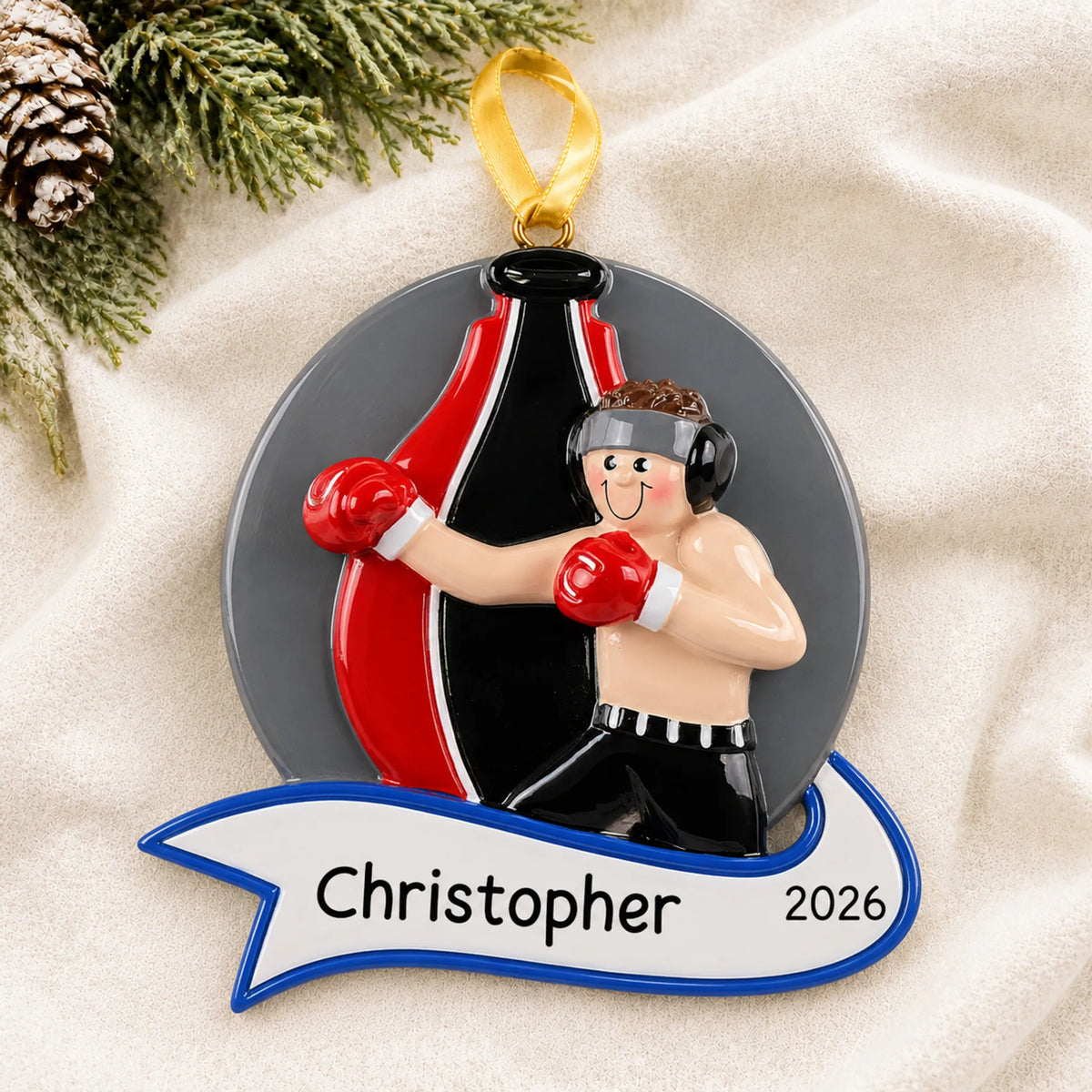 Personalized boxing guy christmas ornament laid on a soft white knit blanket